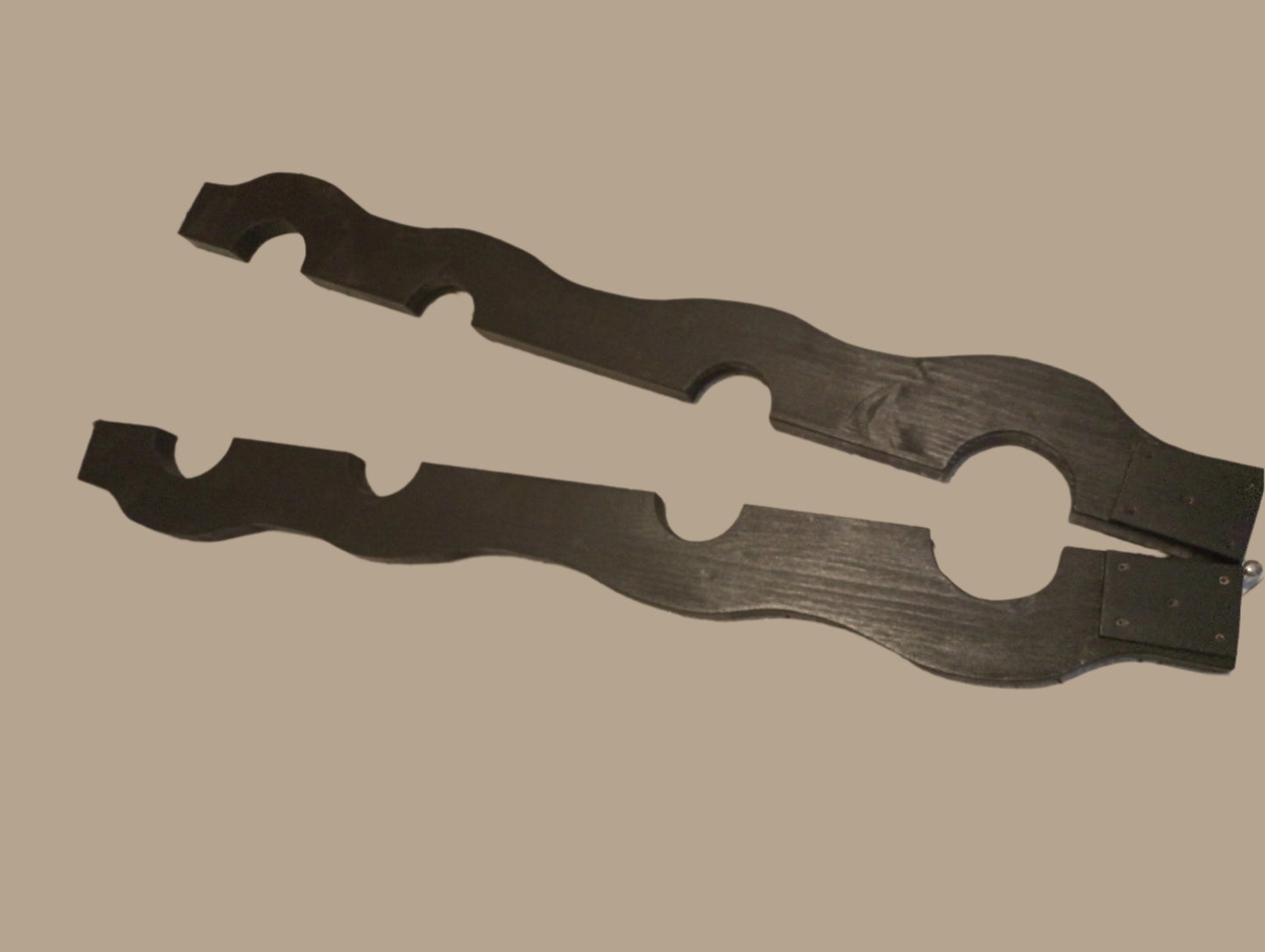 Bondage stock for wrists and ankles in black finish, designed for BDSM play.