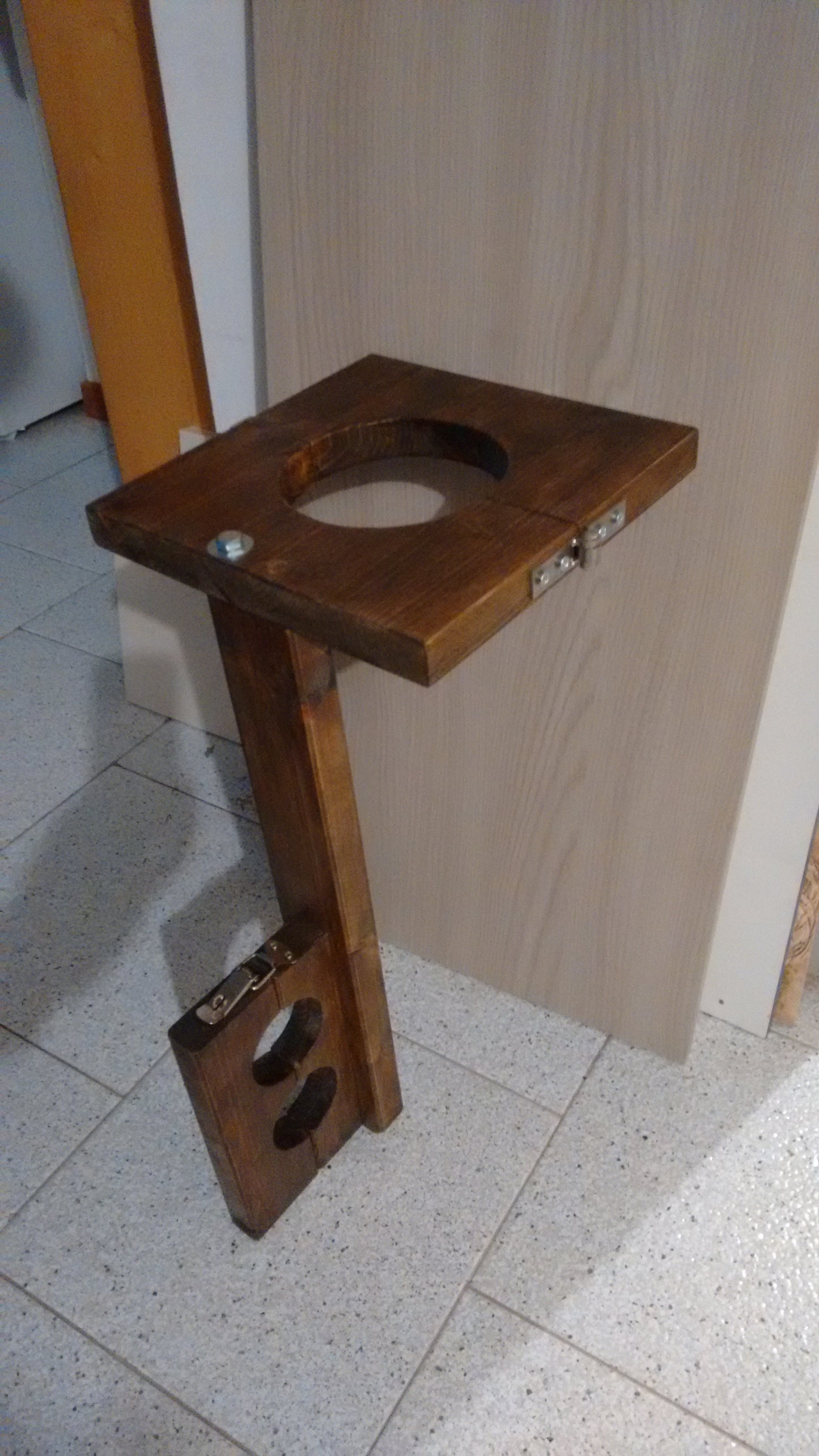 Side view of vertical bondage stock with leash attachment loop.