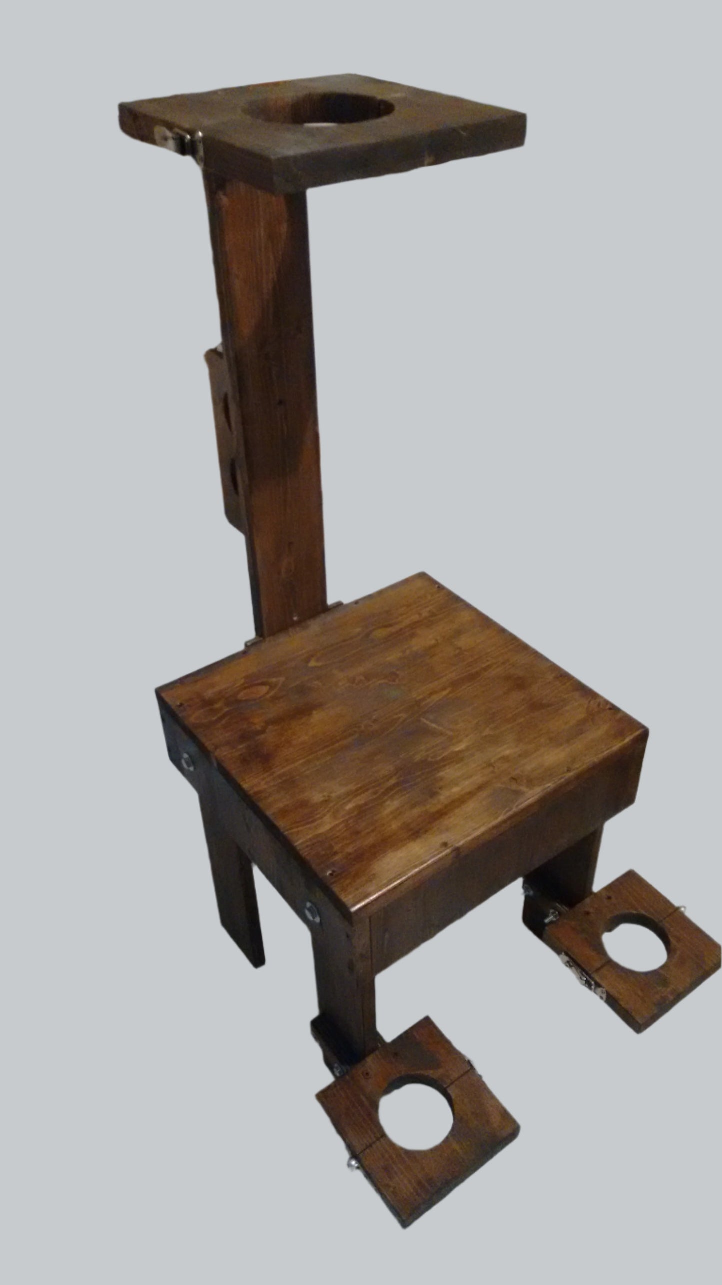 Side view of the wooden interrogation chair for bondage play.