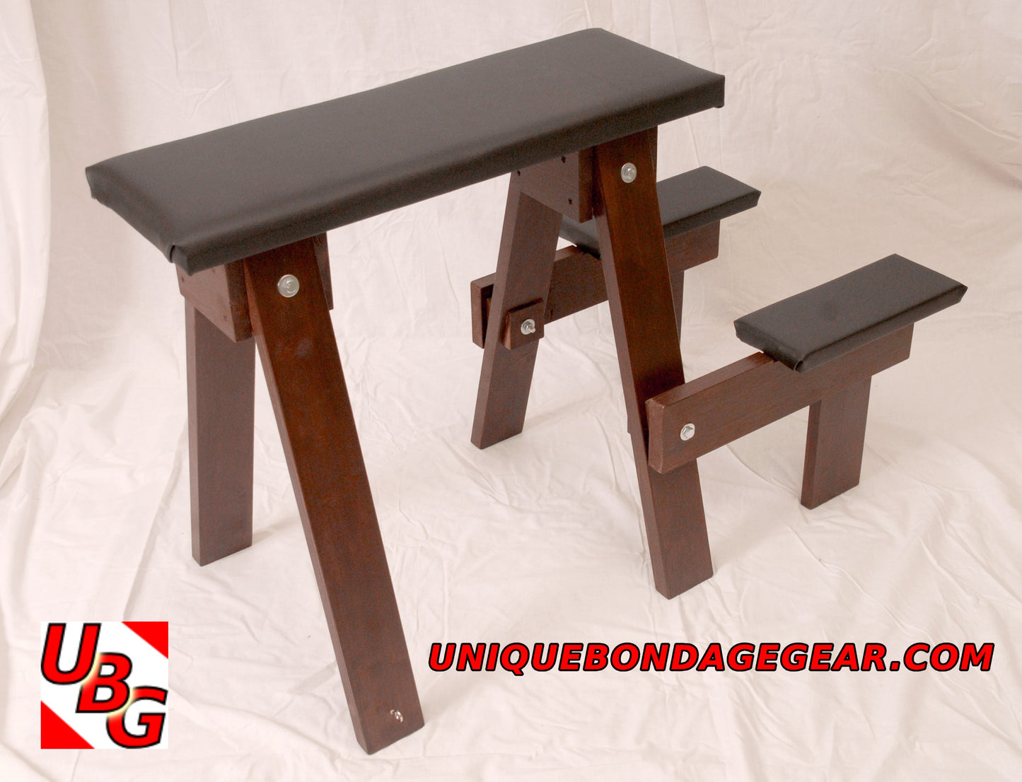 A wooden spanking bench with a padded surface, designed for BDSM play,