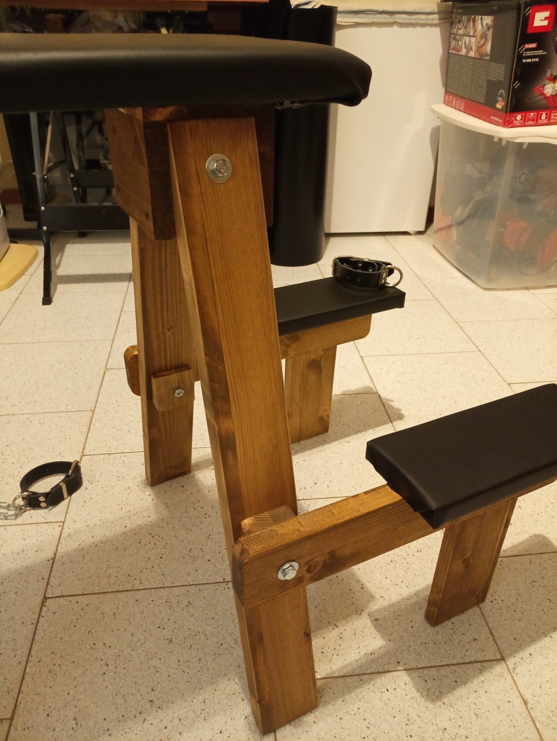 Close-up of high-quality wood craftsmanship on the sturdy spanking bench