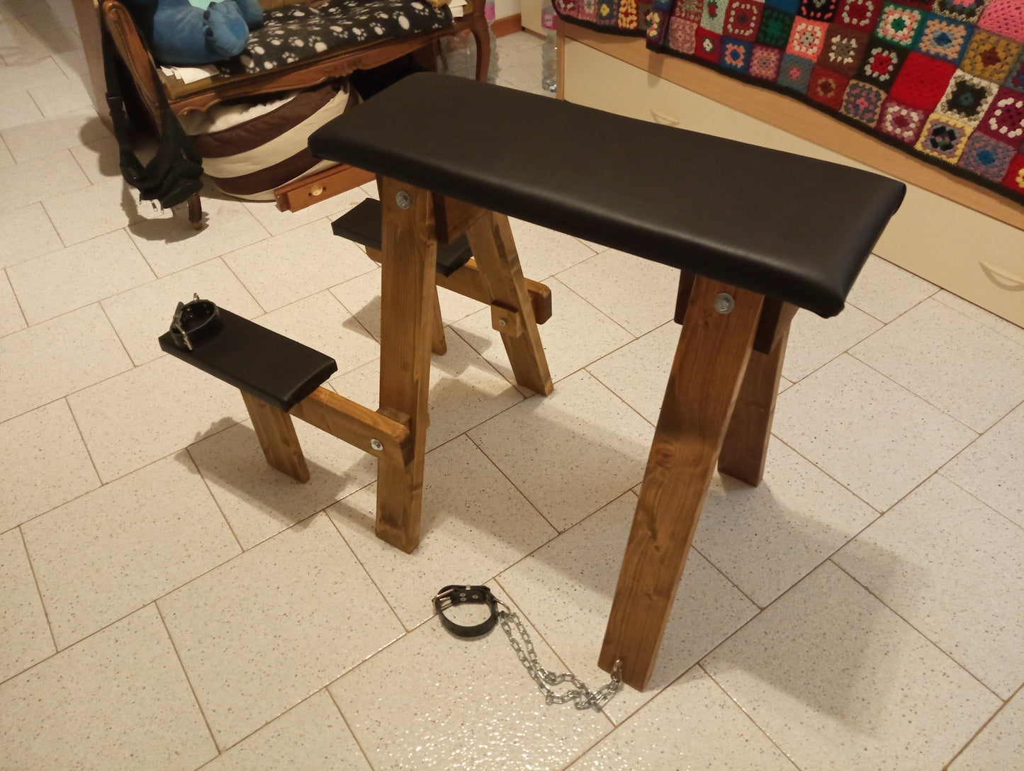 Side view of the solid and functional wooden spanking bench for dungeon use