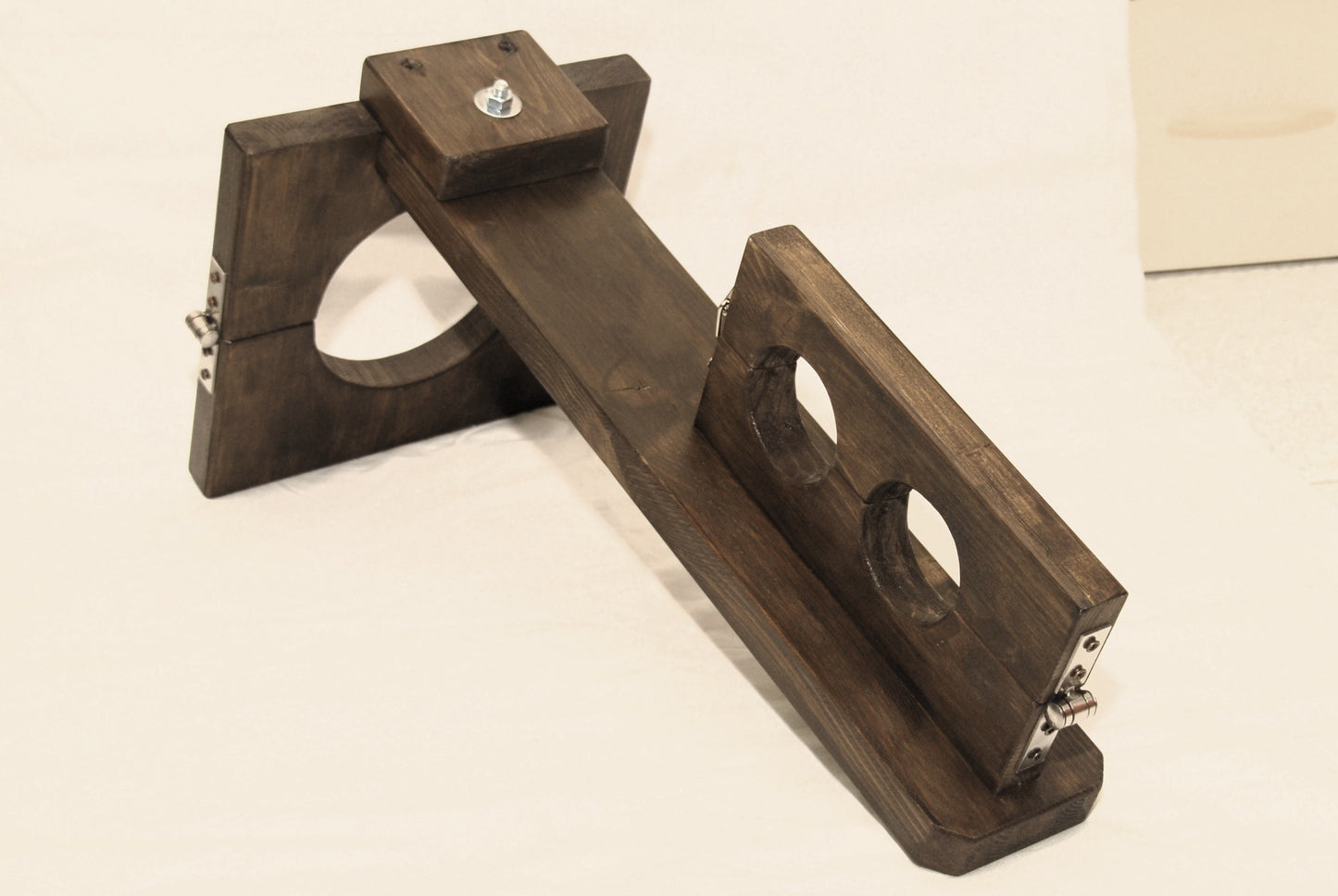 Detail of neck-to-wrist restraint system on vertical wooden BDSM stock – crafted from thick fir wood with wax finish