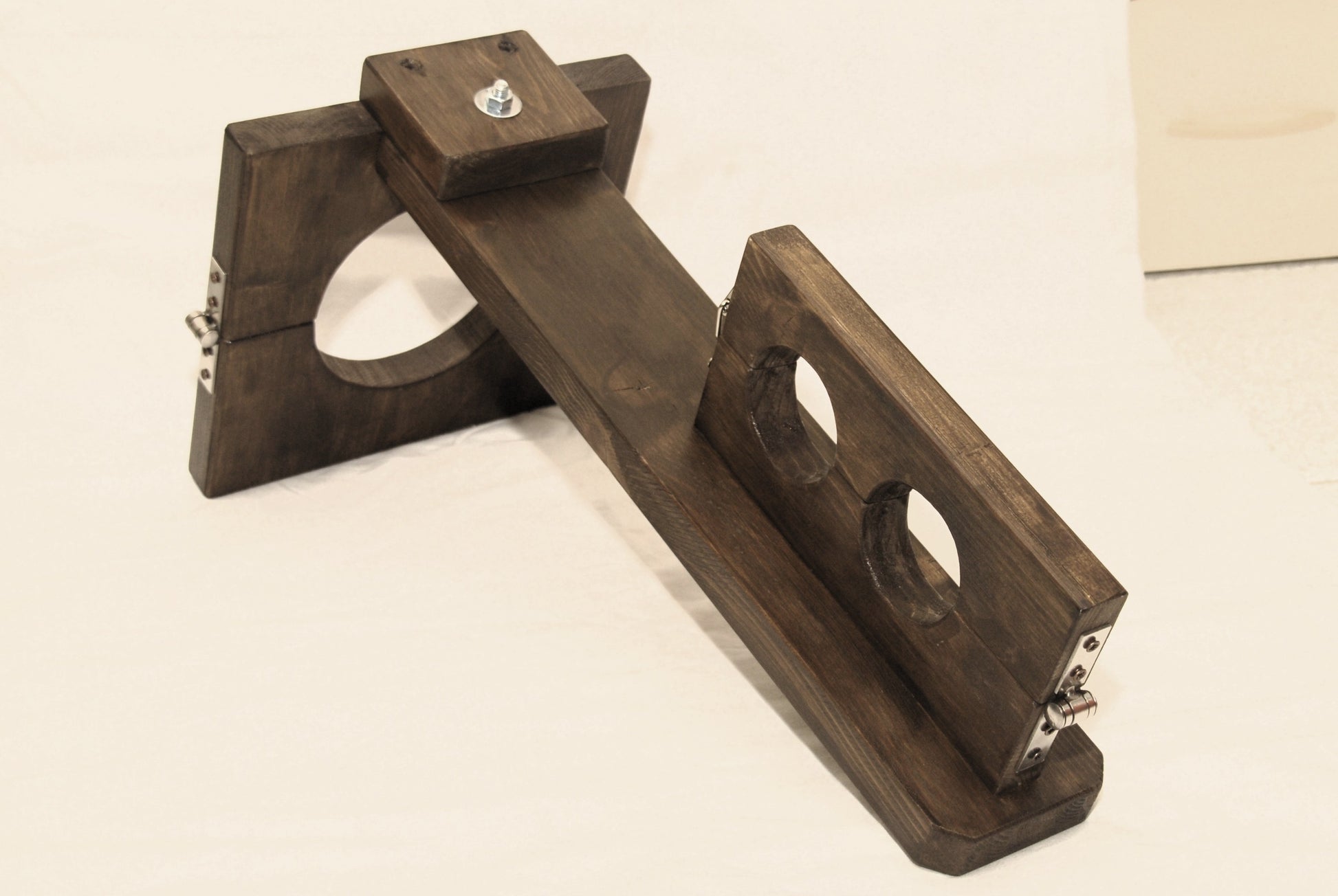 Detail of neck-to-wrist restraint system on vertical wooden BDSM stock – crafted from thick fir wood with wax finish