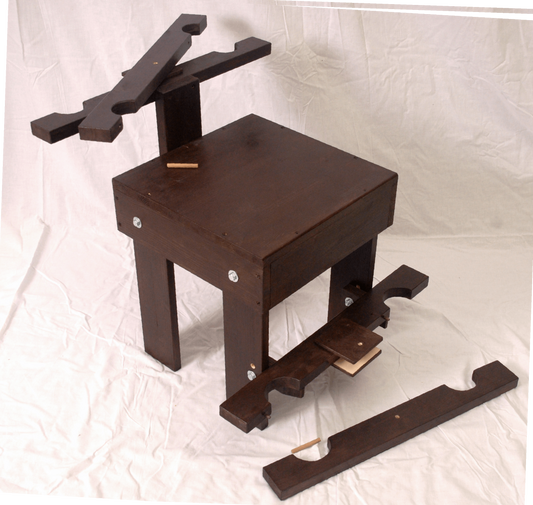 Front view of BDSM wooden chair with wrist and ankle restraints, suitable for dungeon furniture.