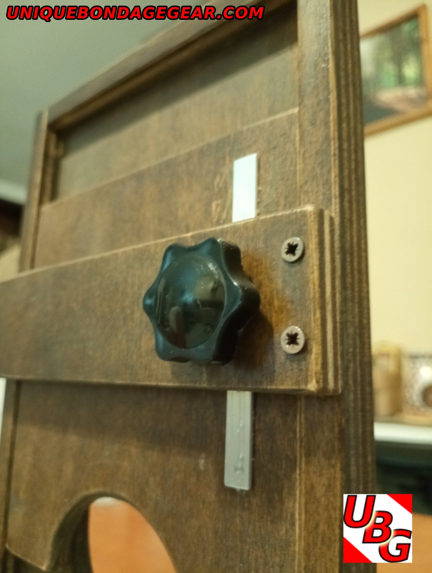 Handmade CBT restraint in walnut-stained plywood – portable, drawer-sized and perfect for versatile dungeon setups