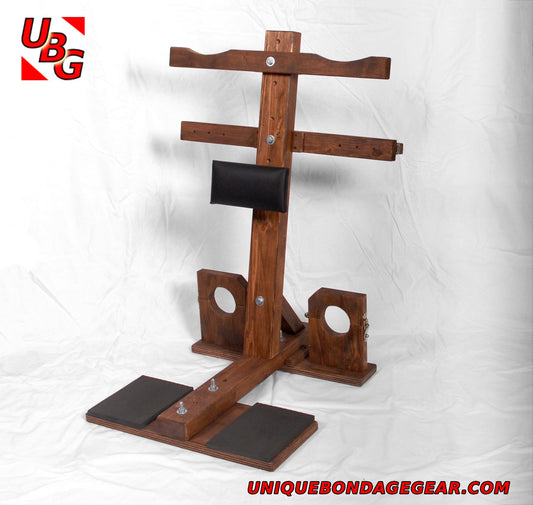 Domination hanger kneeling bench with wrist and ankle stocks for BDSM dungeon use.