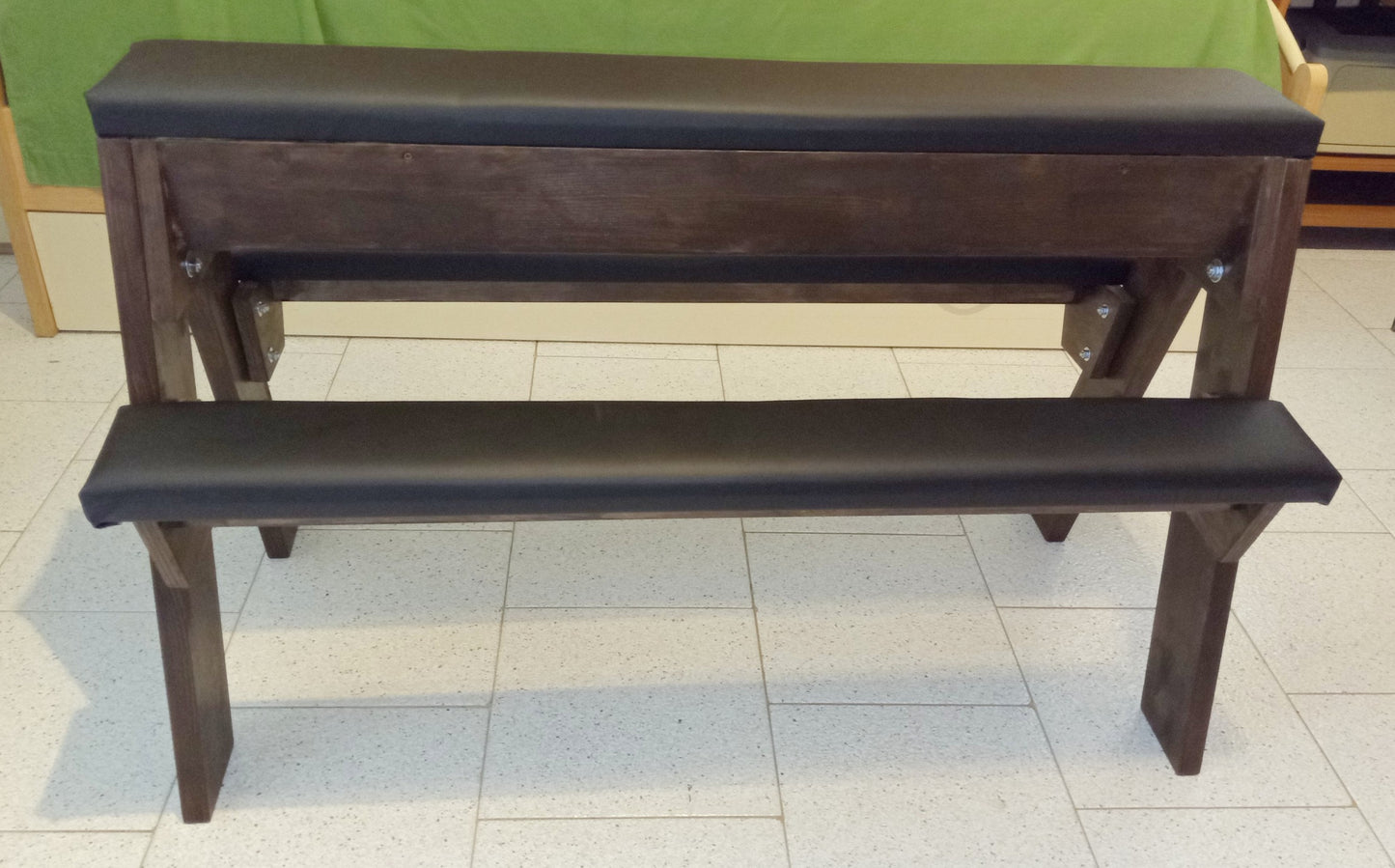 Portable wooden spanking bench with adjustable side supports and heavy-duty handcrafted frame.