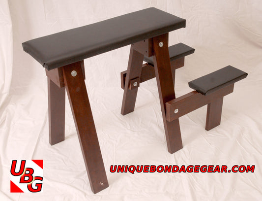 A wooden spanking bench with a padded surface, designed for BDSM play, 